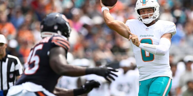 Zach Wilson, Miami Dolphins quarterback, throwing a football.