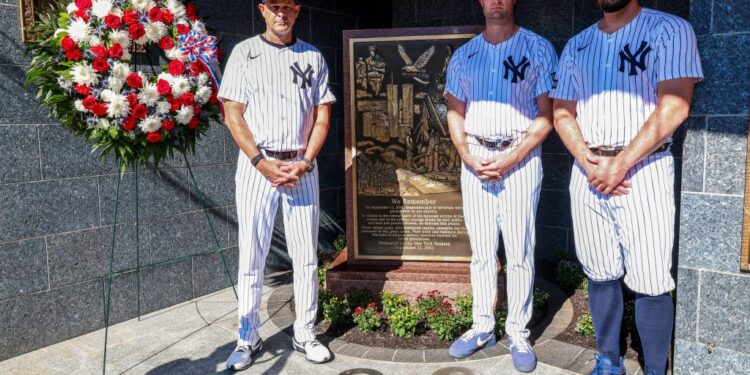 Left to right: Aaron Boone, Gerrit Cole and Carlos Rodón place a wreath on the monument commemorating the 2001 terrorist attacks in Monument Park before the Yankees' 9-3 blowout win over the Tigers on Sept. 11, 2025.