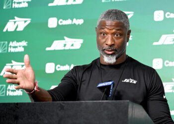 Aaron Glenn talks to the media before practice in Florham Park, NJ.