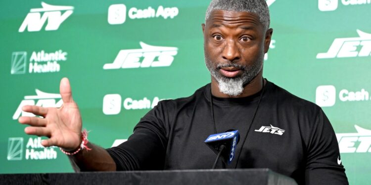Aaron Glenn talks to the media before practice in Florham Park, NJ.