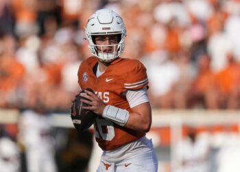 Arch Manning, Texas quarterback, holding a football.