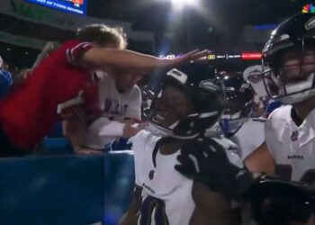 A Bills fan in a red Josh Allen jersey hits Ravens receiver DeAndre Hopkins in the head on Sept. 7, 2025.