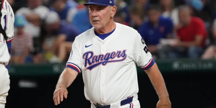 Texas Rangers manager Bruce Bochy walks to the mound for a pitching change.