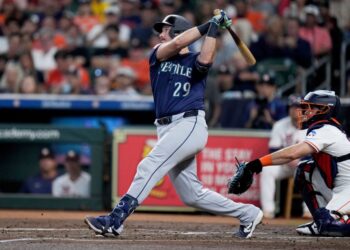 Cal Raleigh hits a solo home run against the Houston Astros.