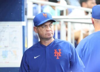 Carlos Mendoza #64 of the New York Mets reacts in the dugout during the fourth inning.