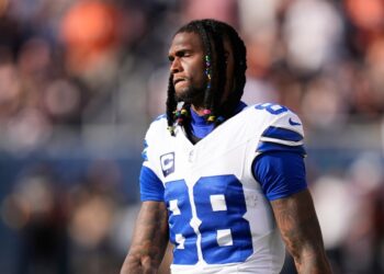 Dallas Cowboys wide receiver CeeDee Lamb walks along the sideline after suffering an unknown injury in the first half of an NFL football game against the Chicago Bears Sunday, Sept. 21, 2025, in Chicago.