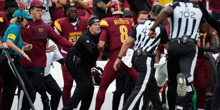 Marcus Mariota collides with Dan Quinn Washington Commanders