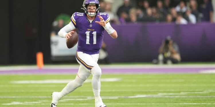 Minnesota Vikings quarterback Carson Wentz looks to throw during a football game.