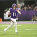Minnesota Vikings quarterback Carson Wentz looks to throw during a football game.