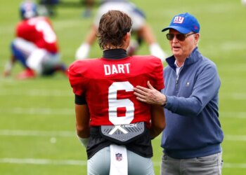 New York Giants owner John Mara speaking with quarterback Jaxson Dart during football practice.