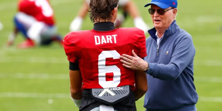 New York Giants owner John Mara speaking with quarterback Jaxson Dart during football practice.