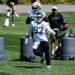 New York Jets player #97 running a drill at practice.
