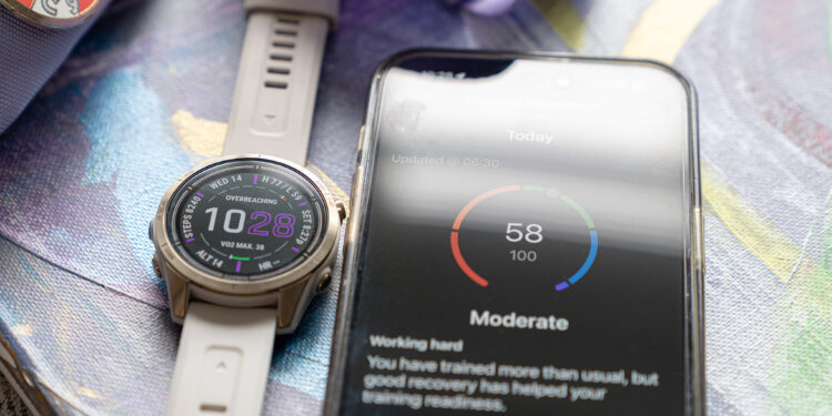 Garmin Epix Pro next to iPhone showing Garmin Connect app