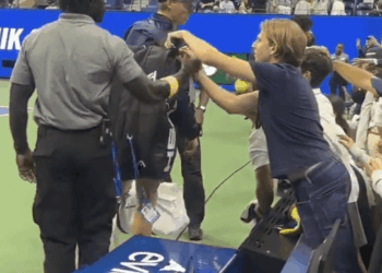 A fan tries reaching into Jannik Sinner's bag at the US Open on Sept. 1, 2025.
