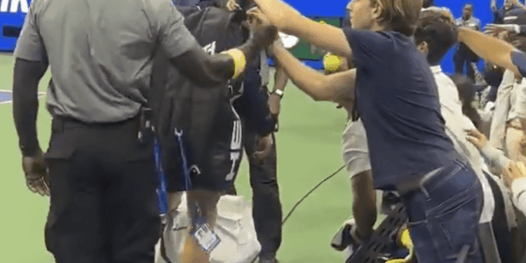 A fan tries reaching into Jannik Sinner's bag at the US Open on Sept. 1, 2025.