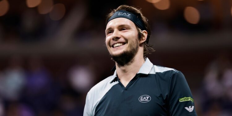 Alexander Bublik of Kazakhstan smiles during a US Open tennis match.