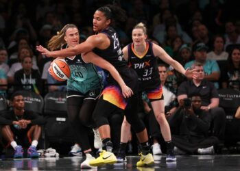 New York Liberty's Sabrina Ionescu (20) defended by Phoenix Mercury's Alyssa Thomas (25) during a basketball game.