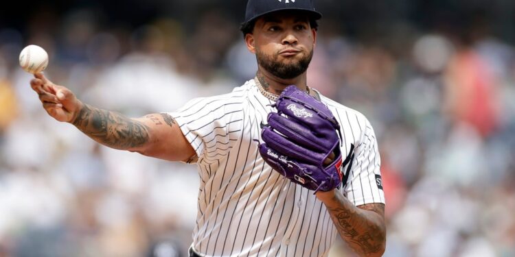 Luis Gil pitching a baseball.