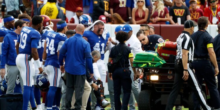 Giants linebacker Micah McFadden is put in a cast after suffering a foot injury during a game against the Commanders on Sept. 7, 2025.