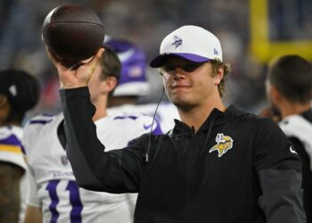 Minnesota Vikings coach holding a football.