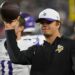 Minnesota Vikings coach holding a football.