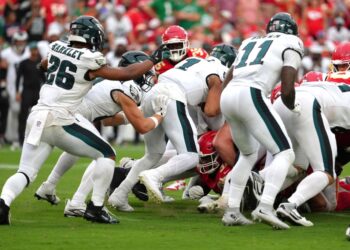 Philadelphia Eagles quarterback Jalen Hurts (1) gets a push from behind from Philadelphia Eagles tight end Grant Calcaterra (81) agains the Kansas City Chiefs in the second half during an NFL football game Sunday, Sept. 14, 2025, in Kansas City, Mo.