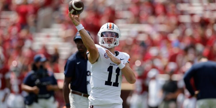Auburn quarterback Jackson Arnold (11) warms up during a college football game.