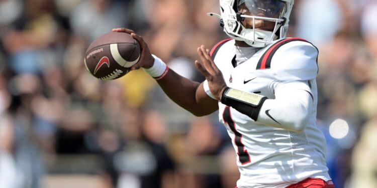 Ball State Cardinals quarterback Kiael Kelly throwing a football.