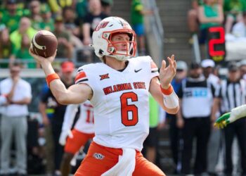 Oklahoma State quarterback Zane Flores throwing a football.