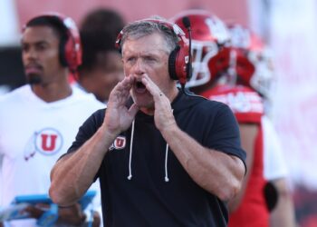 Utah Utes head coach Kyle Whittingham yelling instructions during a football game.