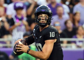 Josh Hoover, TCU quarterback, holding a football.