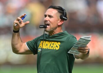 Green Bay Packers head coach Matt LaFleur shouting into his headset.