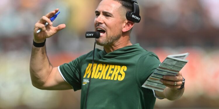 Green Bay Packers head coach Matt LaFleur shouting into his headset.