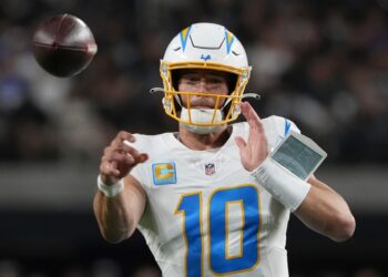 Justin Herbert, Los Angeles Chargers quarterback, throwing a football.