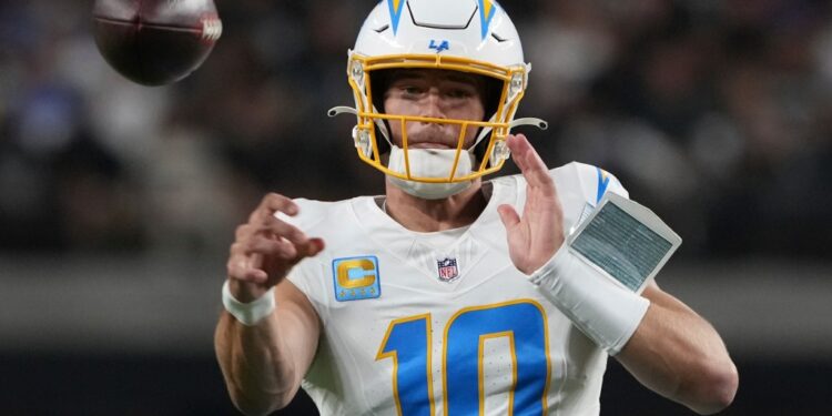 Justin Herbert, Los Angeles Chargers quarterback, throwing a football.