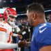 Kansas City Chiefs quarterback Patrick Mahomes and New York Giants quarterback Russell Wilson shaking hands on the field.