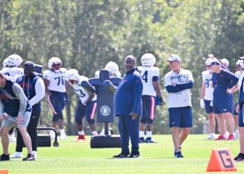 New England Patriots defensive coordinator Terrell Williams watches over practice during training camp.