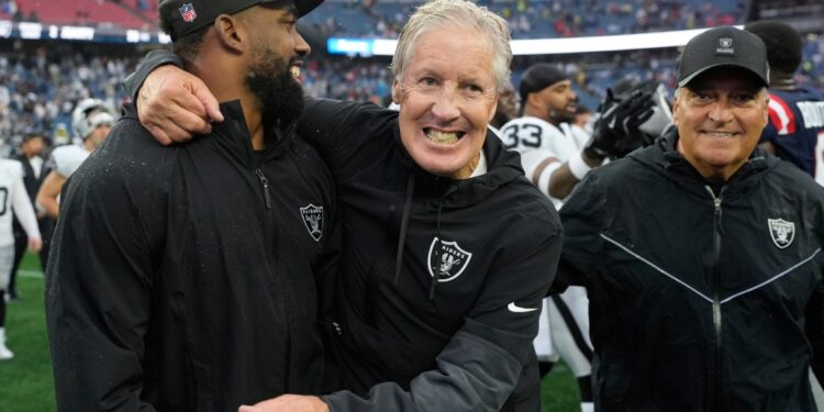 Las Vegas Raiders coaches celebrating after a game.