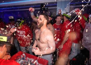 Philadelphia Phillies' Bryce Harper, center, celebrates after the Phillies clinched the NL East following their defeat of the Los Angeles Dodgers in a baseball game Monday, Sept. 15, 2025, in Los Angeles.