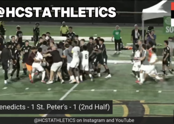 Video still of a soccer game with players celebrating on the field and the score St. Benedicts - 1 St. Peter's - 1 (2nd Half).