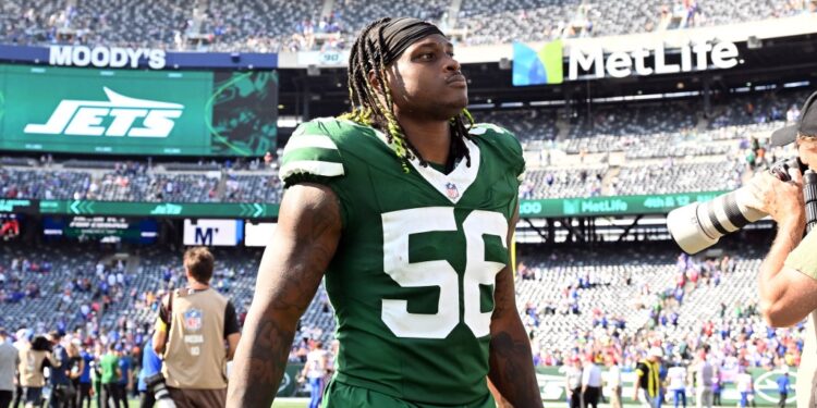 Jets linebacker Quincy Williams (56) walks off the field after losing a football game.