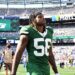 Jets linebacker Quincy Williams (56) walks off the field after losing a football game.