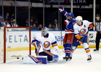 Brennan Othmann (center) celebrates after a first period goal by Vincent Trocheck (not pictured) during the Rangers' 5-4 preseason loss to the Islanders. Othmann scored a goal of his own later in the period.