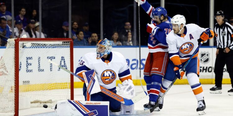 Brennan Othmann (center) celebrates after a first period goal by Vincent Trocheck (not pictured) during the Rangers' 5-4 preseason loss to the Islanders. Othmann scored a goal of his own later in the period.