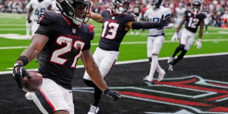 Houston Texans running back Woody Marks (27) celebrates his touchdown.