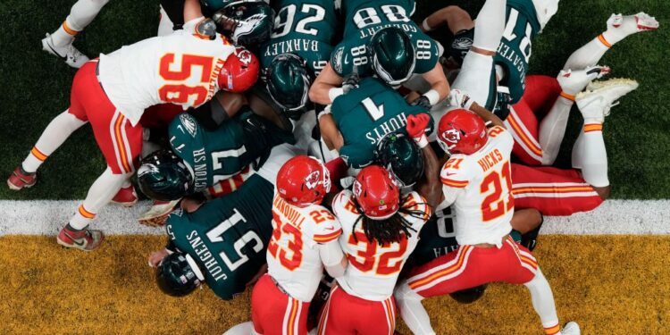 Philadelphia Eagles quarterback Jalen Hurts (1), with help of the tush push from teammates, scores a touchdown against the Kansas City Chiefs during the first half of the NFL Super Bowl 59 football game, Sunday, Feb. 9, 2025, in New Orleans.