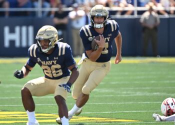 Navy quarterback Blake Horvath (11) runs with the ball as wide receiver Michael Barrow (26) blocks against the Virginia Military Institute Keydets.