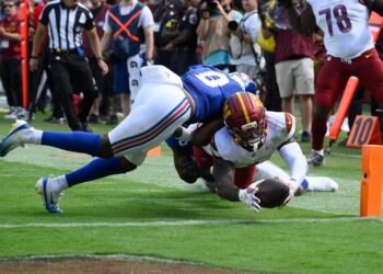 Football player making a touchdown catch.