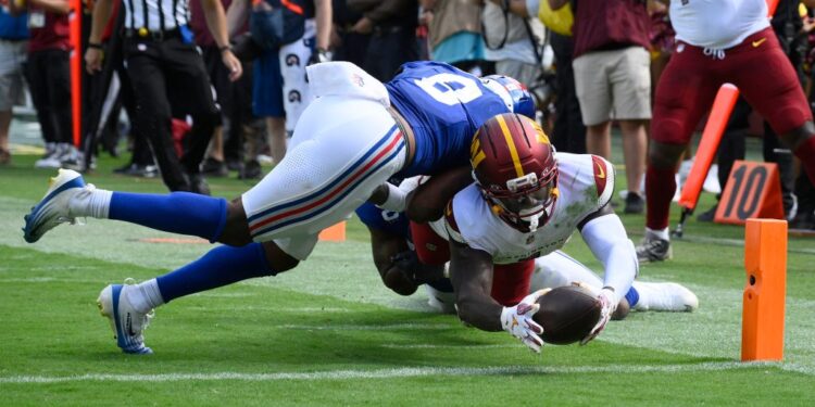Football player making a touchdown catch.
