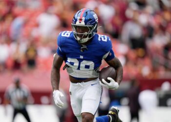 New York Giants football player running with the ball.